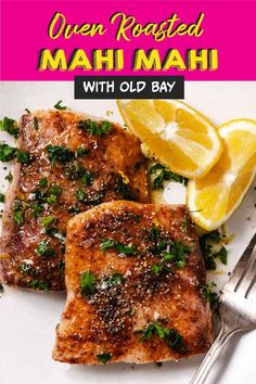 two pieces of salmon on a plate with lemons and parsley