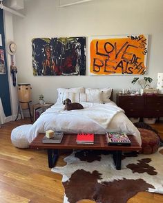 a dog laying on top of a bed in a bedroom