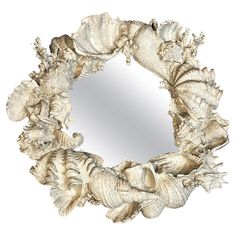 a circular mirror with sea shells around it