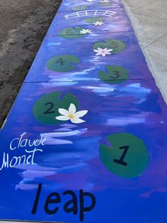 a painted sidewalk with water lilies and numbers on it