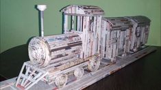 a model of a train made out of newspaper