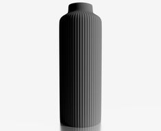 a black vase sitting on top of a white table