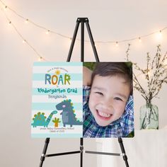 an easel with a photo of a young boy on it and lights in the background