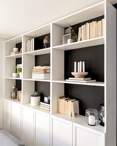 a white book shelf filled with lots of books