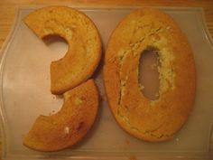 two donuts sitting on top of a plastic tray next to each other with holes in them