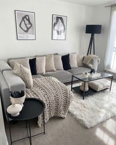 a living room filled with lots of furniture next to a window and a rug on the floor