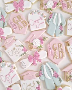 decorated cookies with pink and blue designs on top of each cookie, including baby ones