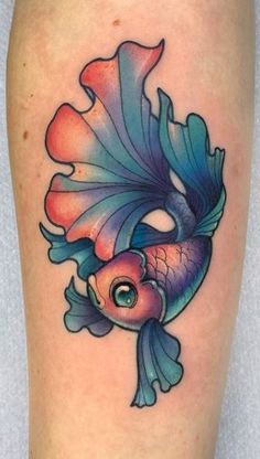 a colorful fish tattoo on the leg