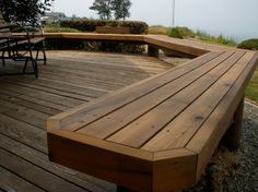 a wooden bench sitting on top of a wooden deck