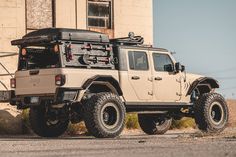 an off - road vehicle parked in front of a building