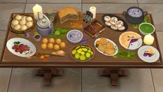 a table filled with lots of food on top of a tiled floor next to a lit candle