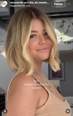 a woman with blonde hair is smiling and looking at the camera while wearing a tan tank top