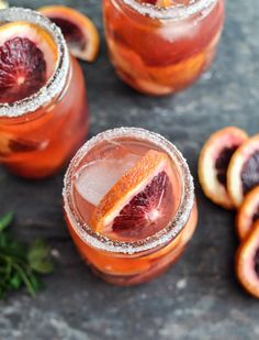 two glasses filled with blood orange margaritas and garnished with grapefruit