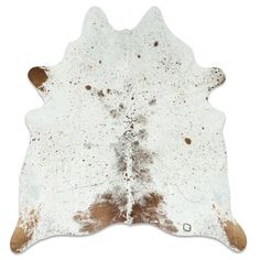 a white and brown cowhide rug with spots on it's side, against a white background