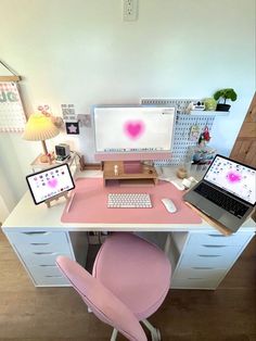 a desk with two laptops and a desktop computer on it