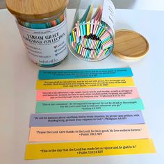 a jar of colored crayons next to some writing paper on a white table