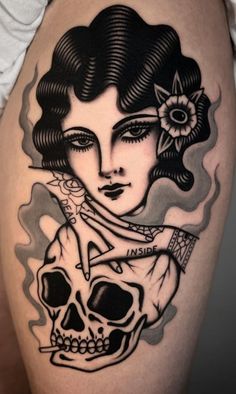 a woman with a skull tattoo on her thigh is shown in black and grey colors