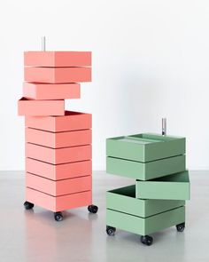 three boxes stacked on top of each other in different colors and sizes, with wheels