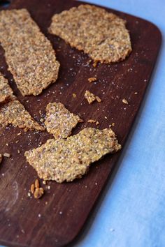 some kind of cracker on a wooden cutting board