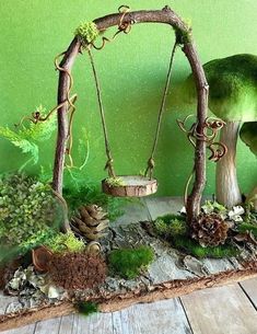 a mossy area with mushrooms, rocks and other things in the background on a wooden table