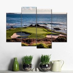 a golf course near the ocean with green grass and water in the foregrounds