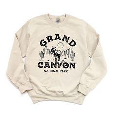 Looking for a cute versatile top to wear this summer? Make sure to grab one of our Vintage Grand Canyon National Park Sweatshirts! This soft and comfortable shirt is the perfect top for any outfit. It can be paired with biker shorts, Jeans, or the classic stay at home sweats! The bright color adds a pop of summer to any outfit. This sweatshirt is true-to-size, so be sure to order your regular size! If you are looking for a more oversized look, make sure to size up. Spring Cotton Sweatshirt For Outdoor Activities, Cotton Sweatshirt For Spring Outdoor Activities, Graphic Print Crew Neck Tops For Outdoor Activities, Spring Crew Neck Tops For Outdoor Activities, Graphic Print Crew Tops, Crew Neck Tops For Outdoor Activities In Spring, Relaxed Fit Text Print Top For Outdoor Activities, Casual Soft-washed Tops For Outdoor Activities, Comfortable Crew Tops With Letter Print