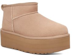 A modern interpretation of UGG's icon, the Ultra Mini reaches new heights with a leg-lengthening 2" platform. Offering a bolder look than ever, it's made with the same rich suede as the original, plus UGG's UGGplush™ wool blend for signature softness. The outsole of this product is either a SugarSole™ outsole, which is a responsible compound using sugarcane foam that allows UGG to reduce dependency on fossil fuels by replacing petroleum-based ethylene, or a Treadlite by UGG™ outsole. DETAILS: Suede upper Overlock stitch detailing on seams, Rear pull tab, Asymmetrical topline 17mm UGGplush™ 80% upcycled wool, 20% TENCEL™ Lyocell lining or 17mm UGGplush™ 60% upcycled wool, 40% TENCEL™ Lyocell lining 17mm UGGplush™ 80% upcycled wool, 20% TENCEL™ Lyocell insole or 17mm UGGplush™ 60% upcycled w Ugg Ultra Mini, Platform Boots Women, Ugg Classic Ultra Mini, Jerome Dreyfuss, Ugg Classic Mini, Zadar, Vanessa Bruno, Ugg Classic, Classic Mini