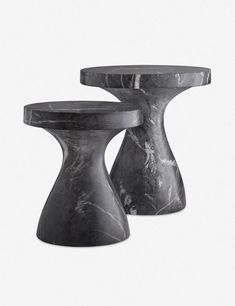 two black marble side tables sitting next to each other