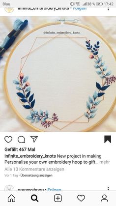 an embroidery project with flowers and leaves on it, in the middle of a tweep