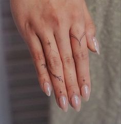 a woman's hand with two small stars on her left thumb and the middle finger