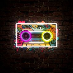 an old school radio with neon lights in the shape of a boombox on a brick wall