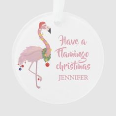 a pink flamingo christmas ornament hanging from a white string with the words have a flamingo christmas written on it