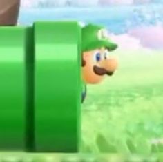 mario kart is peeking out from behind a green barrel