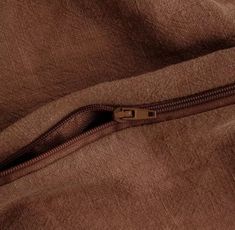 an open zipper on a brown jacket