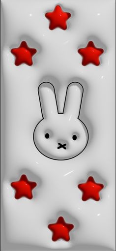 a white rabbit with red stars around it