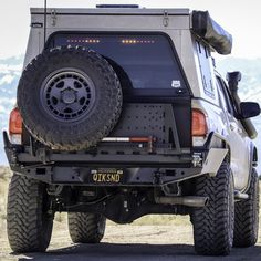 an off - road vehicle is parked in the desert