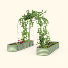 two metal planters with plants growing in them