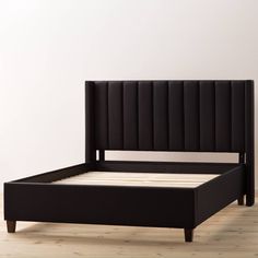 a black bed frame with no headboard and foot board is shown in an empty room