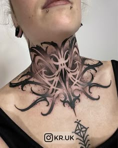 a woman with tattoos on her neck is looking at the camera and has an intricate design