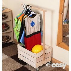 a wooden crate filled with clothes next to a mirror