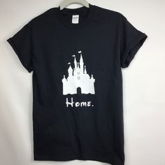 a black t - shirt with the word home printed on it and a castle silhouette