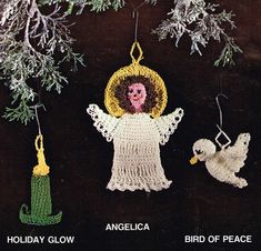 an angel ornament hanging from a tree next to two white birds and snowflakes