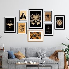 a living room filled with furniture and framed pictures on the wall above a coffee table