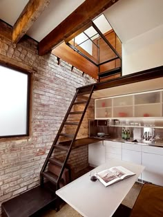 a loft apartment with exposed brick walls and stairs