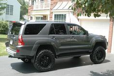 a gray suv parked in front of a house