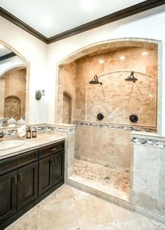 a large bathroom with two sinks and a walk in shower