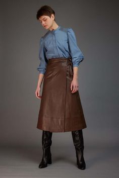 Love binetti kaia brown leather skirt    expertly crafted from a supple and rich brown leather this midi skirt is detailed with a stylish yet uncomplicated silhouette. combining modern charm with timeless sophistication this is a beautifully refined choice that you can wear for any occasion.    pivot pairings: pair with the not monday black emma cashmere sweater and loeffler randall black gia boots or the binetti red silk blouse.    details    materials:    - 100% leather    sizing and fit:    - runs true to size  - hook and eye closure  - double tie waist Gia Boots, Red Silk Blouse, Long Leather Skirt, Brown Leather Skirt, Blouse Details, Autumn Trends, Skirts With Boots, Long Skirts For Women, Denim Trends