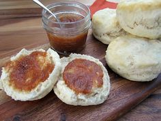 some biscuits are sitting on a wooden cutting board