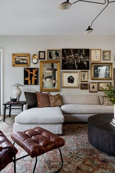 a living room filled with furniture and pictures on the wall