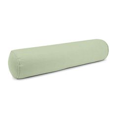 a large green pillow sitting on top of a white floor